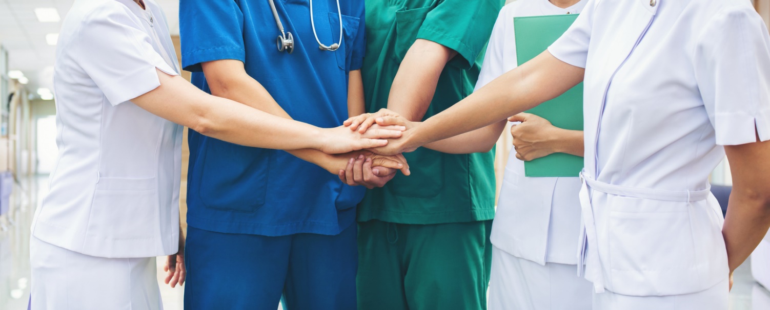 A group of people holding hands together Description automatically generated with low confidence