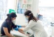 A person wearing a mask and gloves Description automatically generated with low confidence
