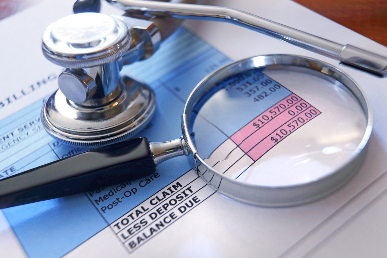 A magnifying glass and a stethoscope on a document Description automatically generated